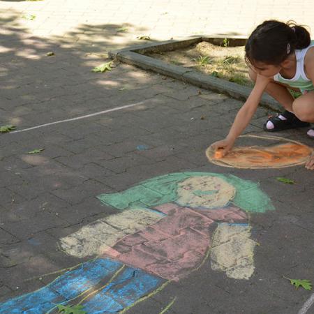 Postać dziewczynki z zielonymi włosami narysowana na chodniku 