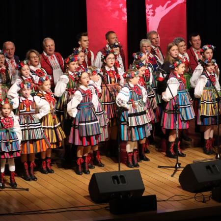 Grupa artystów w strojach regionalnych występują