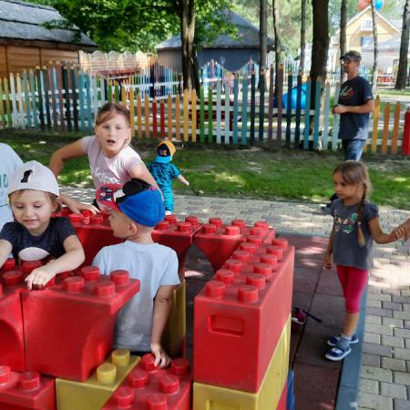 Dzieci na placu zabaw bawią się ogromnymi klockami lego