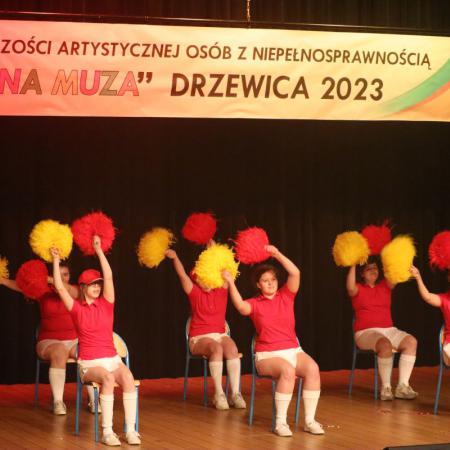 Dziewczyny tańczą na scenie z pomponami
