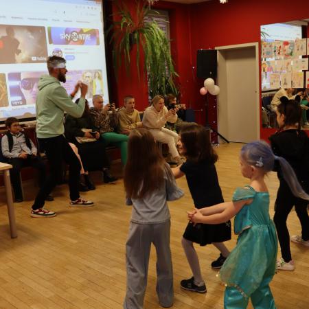 Instruktor Szymon Gwadera pokazuje taniec dzieciom 